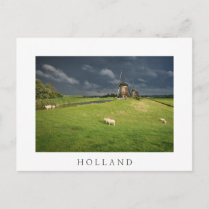 Sheep with windmills under dark clouds postcard