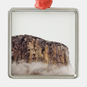 Sheer cliff rising above clouds metal tree decoration