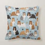 Sheltie Bones and Paws Cushion<br><div class="desc">Cute Shetland Sheepdog dogs sit and stand and rollover with sable,  tri-color,  merle and white coats with scattered dog bones and pawprints pattern.</div>