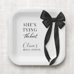 She's Tying The Knot Black Bow Party Paper Plate<br><div class="desc">Party paper plates designed with a classic black bow motif and the phrase shes tying the knot. Created for a clean, elegant table setting that pairs well with black and white wedding decor. Suitable for bridal showers, engagement parties, bachelorette gatherings, and wedding celebrations. Fully customizable text with a print-ready design...</div>