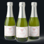 She's Tying the Knot Coquette Bow Bridal Shower Sparkling Wine Label<br><div class="desc">This charming bridal shower invitation in soft pink with a delightful bow design sets the perfect tone for a Soft Pink Coquette Bridal Shower. The delicate colour scheme and elegant design make it a sweet choice for celebrating the bride-to-be!</div>
