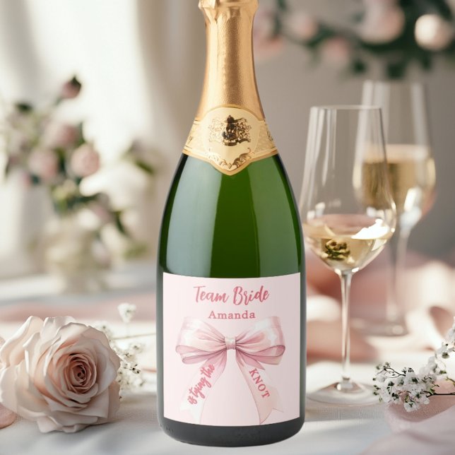She's tying the knot pink bow Team Bride Sparkling Wine Label (Creator Uploaded)