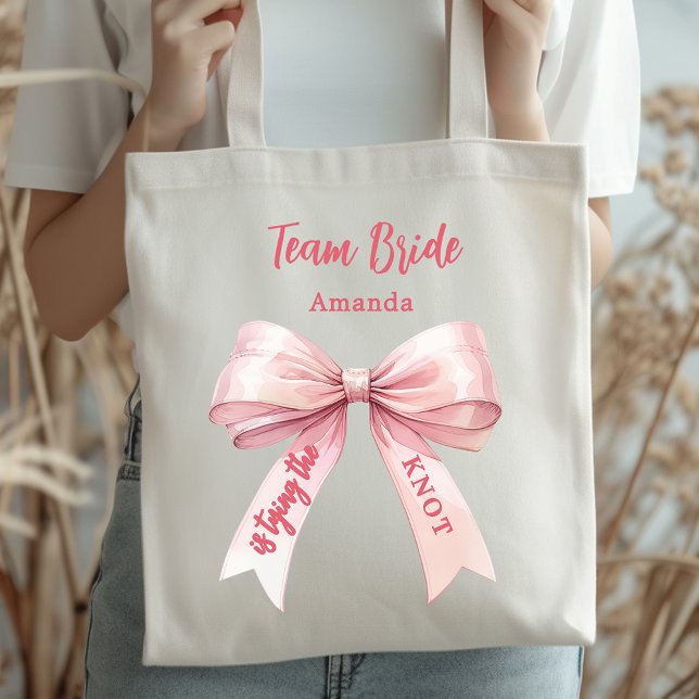 She's tying the knot pink bow Team Bride Tote Bag (Creator Uploaded)