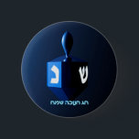 Shiny Blue Dreidel 6 Cm Round Badge<br><div class="desc">A modernistic,  metallic blue dreidel against a dark,  night-like background.  Two of the Hebrew letters found on a dreidel,  nun and shin,  glow brightly.  Hebrew text reading "Chag Chanukkah Sameach" (Happy Hanukkah) also appears in glowing blue and white.</div>