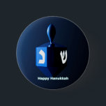 Shiny Blue Dreidel 6 Cm Round Badge<br><div class="desc">A modernistic,  metallic blue dreidel against a dark,  night-like background.  Two of the Hebrew letters found on a dreidel,  nun and shin,  glow brightly.  Text reading "Happy Hanukkah" also appears in glowing blue and white.</div>