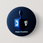 Shiny Blue Dreidel 6 Cm Round Badge<br><div class="desc">A modernistic,  metallic blue dreidel against a dark,  night-like background.  Two of the Hebrew letters found on a dreidel,  nun and shin,  glow brightly.  Text reading "Happy Hanukkah" also appears in glowing blue and white.</div>