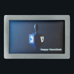 Shiny Blue Dreidel Belt Buckle<br><div class="desc">A modernistic,  metallic blue dreidel against a dark,  night-like background.  Two of the Hebrew letters found on a dreidel,  nun and shin,  glow brightly.  Text reading "Happy Hanukkah" also appears in glowing blue and white.</div>