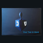 Shiny Blue Dreidel Placemat<br><div class="desc">A modernistic,  metallic blue dreidel against a dark,  night-like background.  Two of the Hebrew letters found on a dreidel,  nun and shin,  glow brightly.  Add your own text.</div>