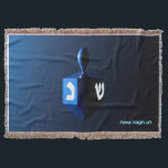 Shiny Blue Dreidel Throw Blanket<br><div class="desc">A modernistic,  metallic blue dreidel against a dark,  night-like background.  Two of the Hebrew letters found on a dreidel,  nun and shin,  glow brightly.  Hebrew text reading "Chag Chanukkah Sameach" (Happy Hanukkah) also appears in glowing blue and white.</div>