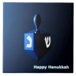 Shiny Blue Dreidel Tile<br><div class="desc">A modernistic, metallic blue dreidel against a dark, night-like background. Two of the Hebrew letters found on a dreidel, nun and shin, glow brightly. Text reading "Happy Hanukkah" also appears in glowing blue and white.</div>