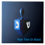 Shiny Blue Dreidel Tile<br><div class="desc">A modernistic,  metallic blue dreidel against a dark,  night-like background.  Two of the Hebrew letters found on a dreidel,  nun and shin,  glow brightly.  Add your own text.</div>