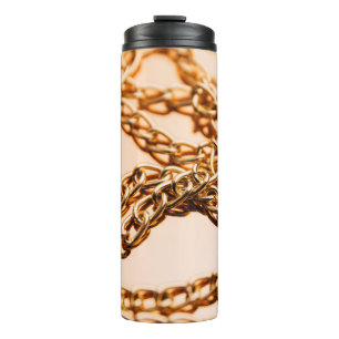 Shiny golden chains on reflective surface. Seamles Thermal Tumbler