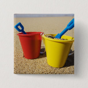 Shovels And Pails On Sandy Beach 15 Cm Square Badge