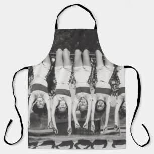 Showgirls on monkey bars, playful design. apron