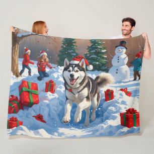 Siberian Husky Running in Snow with Christmas Hat Fleece Blanket