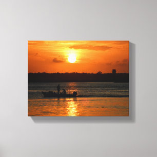Silhouette of a boat at sunset canvas print