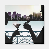 Silhouette of a couple toasting martini glasses