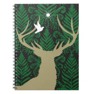 Silhouette of a deer, a dove and a star against a notebook