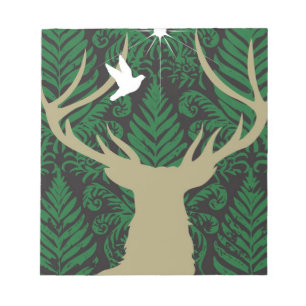 Silhouette of a deer, a dove and a star against a notepad