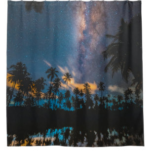 Silhouette of coconut trees reflected on body of w shower curtain