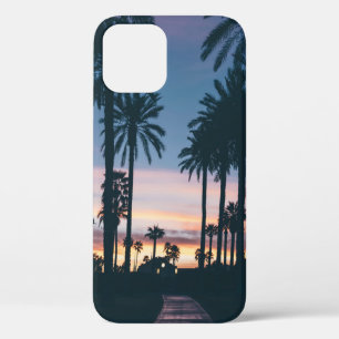 Silhouette of houses beside palm trees and pathway iPhone 12 case