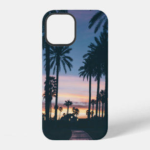 Silhouette of houses beside palm trees and pathway iPhone 12 case