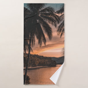 Silhouette of palm tree during golden hour bath towel