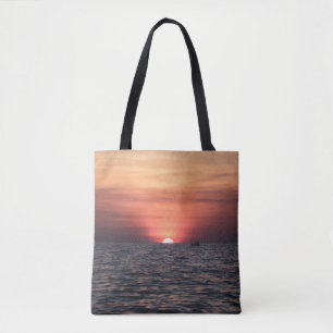 SILHOUETTE OF PERSON ON BODY OF WATER DURING SUNSE TOTE BAG