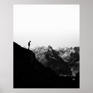SILHOUETTE OF PERSON STANDING ON CLIFF IN FRONT OF POSTER