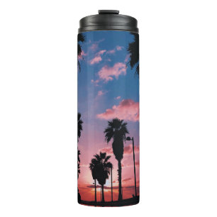 Silhouette of tree under cloudy sky thermal tumbler