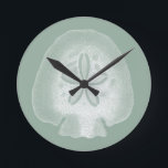 Silhouette Sand Dollar Round Clock<br><div class="desc">Can you imagine living your life on the beach? Get this beautiful image of this silhouette sand dollar to add to your beach collection. This unique translucent piece of art work is great on any of your Zazzle products. It's contemporary and modern art will make you the most stylish among...</div>