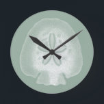 Silhouette Sand Dollar Round Clock<br><div class="desc">Can you imagine living your life on the beach? Get this beautiful image of this silhouette sand dollar to add to your beach collection. This unique translucent piece of art work is great on any of your Zazzle products. It's contemporary and modern art will make you the most stylish among...</div>