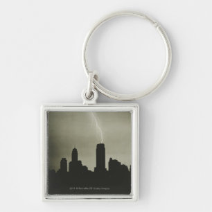 Silhouettes of skyscrapers and lightning in sky key ring