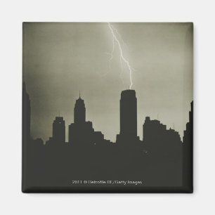 Silhouettes of skyscrapers and lightning in sky magnet
