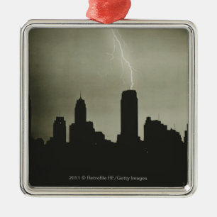 Silhouettes of skyscrapers and lightning in sky metal tree decoration