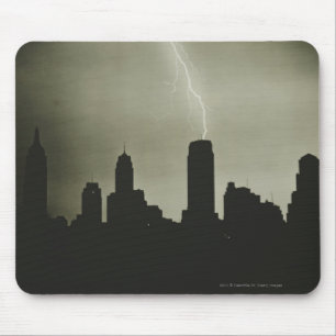 Silhouettes of skyscrapers and lightning in sky mouse mat