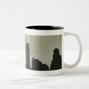 Silhouettes of skyscrapers and lightning in sky Two-Tone coffee mug