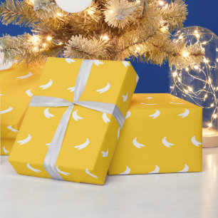 Silhouettes of Small White Bananas on Yellow Wrapping Paper