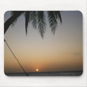 Silhuetted empty hammock at sunset mouse mat