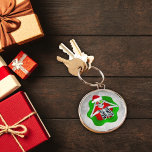 Silly Christmas Skeleton Ornaments Santa Hat Green Key Ring<br><div class="desc">This key chain has a silly Christmas skeleton looking out from an abstract bright red and green splatter shape holding two round ornaments up to his eyes wearing a red fur trimmed Santa Hat on a white abstract background with circles.</div>