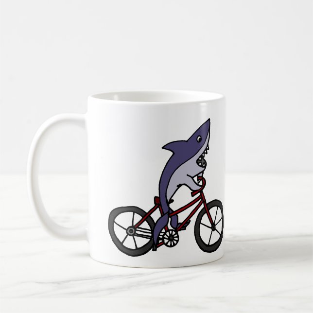 Silly Shark Riding Bicycle Cartoon Coffee Mug (Left)