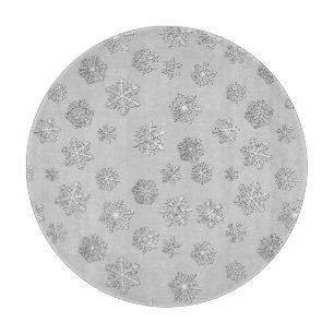 Silver 3-d snowflakes on a silver background cutting board