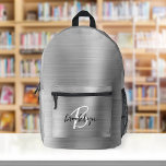 Silver Brushed Metal Black White Script Monogram  Printed Backpack<br><div class="desc">This personalised backpack features a monogram and first name in modern black and white script on an elegant silver faux brushed metal background.</div>