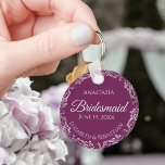 Silver Lace Cassis Purple Bridesmaid Wedding Key Ring<br><div class="desc">These beautiful bridesmaid keychains are designed to be given as a gift or wedding favour. The design is simple yet elegant and features a frilly silver grey faux foil border with pale grey text on a cassis purple, magenta or berry coloured background. There is space for her name, the wedding...</div>