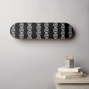 Silver spirals pattern on black skateboard
