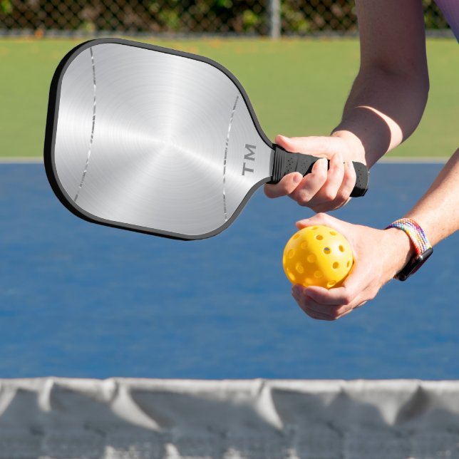 Silver tones background, shiny silver stripe pickleball paddle (Insitu)