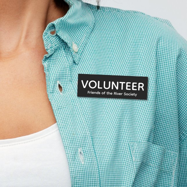 Simple Classic Volunteer Badge Name Tag (Woman in blue shirt wearing this customizable volunteer name tag badge with white letters on black.)