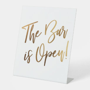 Simple Gold Handwriting Typography The Bar is Open Pedestal Sign