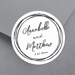 Simple Minimalist Names Red Hand Drawn Wedding Classic Round Sticker<br><div class="desc">Simple Minimalist Wedding Stickers with Black Doodle Frame. These charming square wedding stickers feature the bride and groom's names and wedding date displayed in a mix of clean and stylish fonts. Surrounding the design is a playful hand-drawn black doodle frame of messy circles, adding a fun and whimsical touch. Fully...</div>