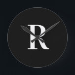 Simple Monogram Black and White Round Clock<br><div class="desc">This is a simple, modern, personalised monogram design. This stylish design is in classic black and white with stylish typography. It's perfect for a personalised gift or ideal as a new addition to your home decor. Simply add your initial letter by typing it into the personalise this text box. Check...</div>